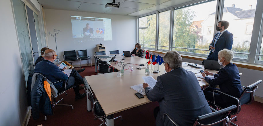 Teilnehmer an einer Online-Konferenz in einem Sitzungsraum